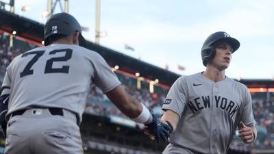 New York Yankees' Ben Rice, right, is congratulated by José Caballero (72) after scoring against the San Francisco Giants during the fifth inning of a baseball game in San Francisco, Wednesday, March 25, 2026. (AP Photo/Jeff Chiu)