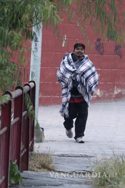 $!Humberto N camina hacia las vías del tren envuelto en una cobija. Para él el frío no es más que otra de las muchas condiciones en las que tiene que viajar.
