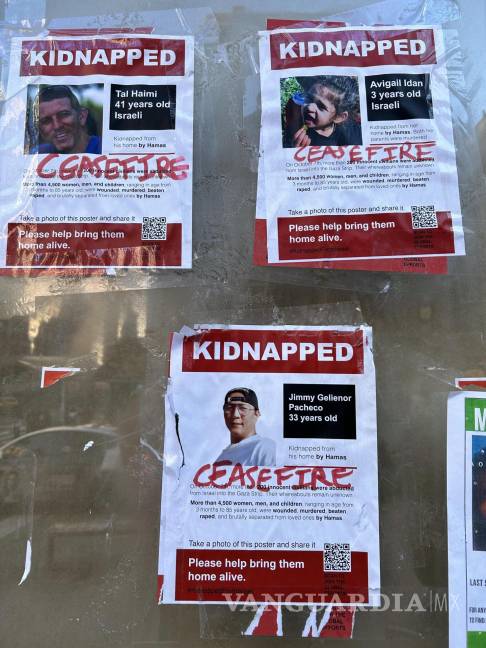 $!Vista de varios carteles con imágenes de personas secuestradas por Hamás, tapados por el mensaje cese el fuego en una calle de Nueva York.
