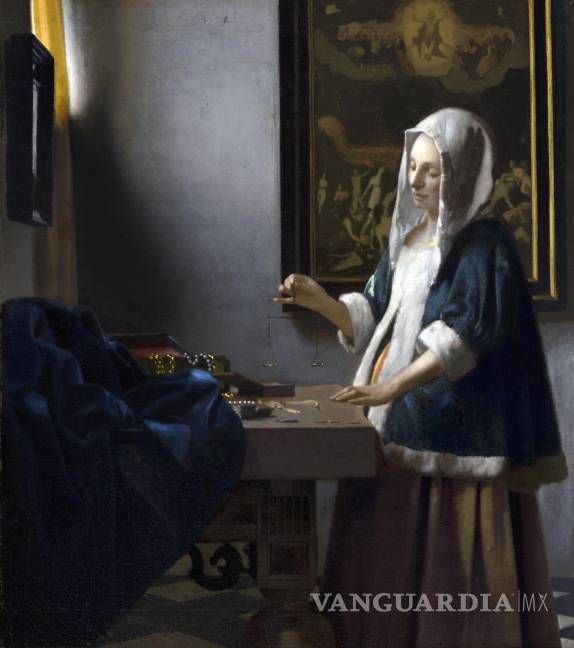 $!La obra Woman holding a balance (Mujer sosteniendo una balanza) atribuida al pintor neerlandés Johannes Vermeer y posiblemente pintada en 1664.
