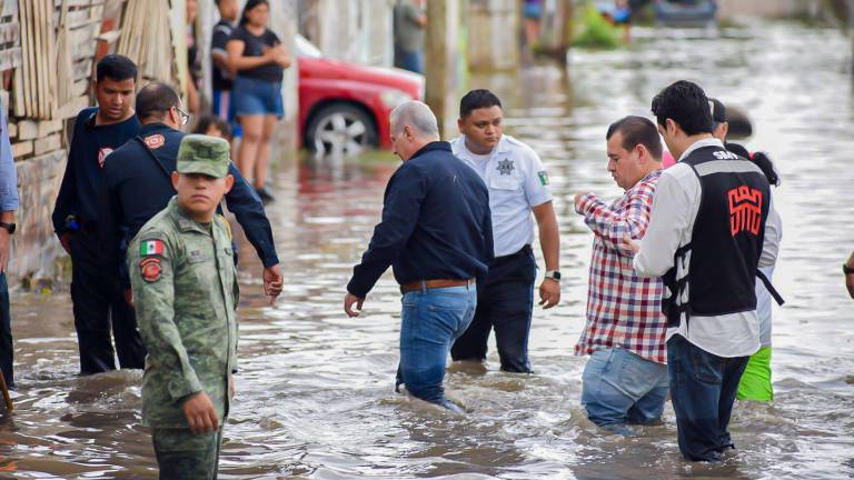 $!El alcalde de Torreón, Román Alberto Cepeda González, camina las calles de la colonia Santiago Ramírez, la más afectada por las inundaciones pluviales.