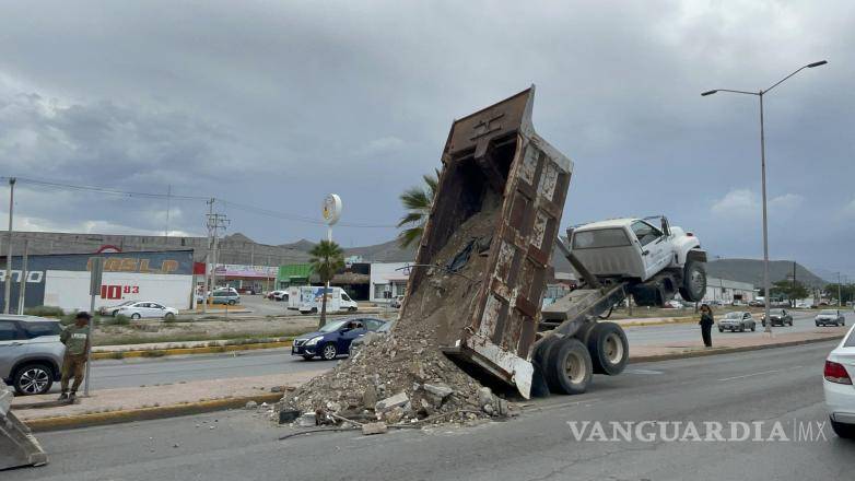 $!La unidad transportaba escombros al relleno sanitario cuando ocurrió el desperfecto, que dejó la cabina suspendida sobre el bulevar Luis Echeverría.