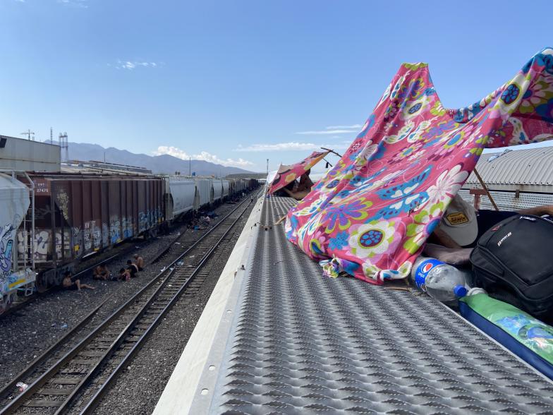 $!En el techo del tren, los migrantes improvisan para viajar con menos molestias.