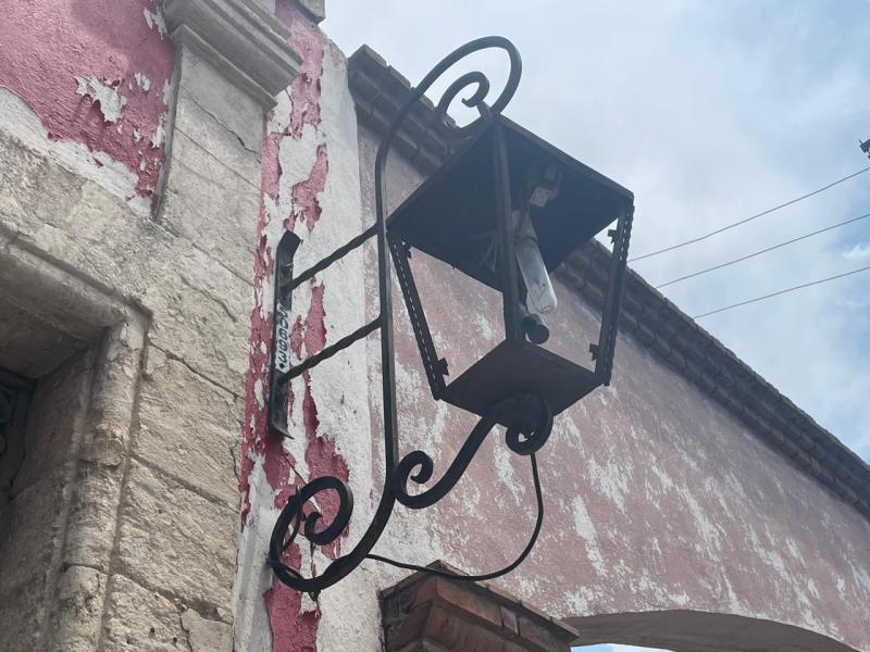 $!  Two lampposts with broken glass hang from the facade of Rubén Herrera's historic house.