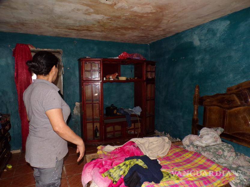 $!Ricarda muestra los muebles hinchados y las paredes mojadas de su casa tras las lluvias.