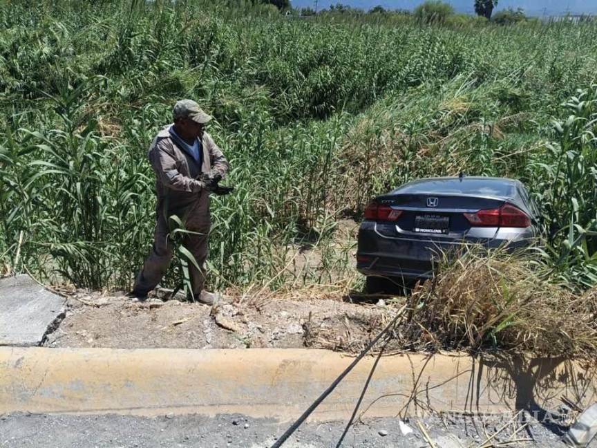$!Elementos de rescate apoyan a la conductora que cayó al río.