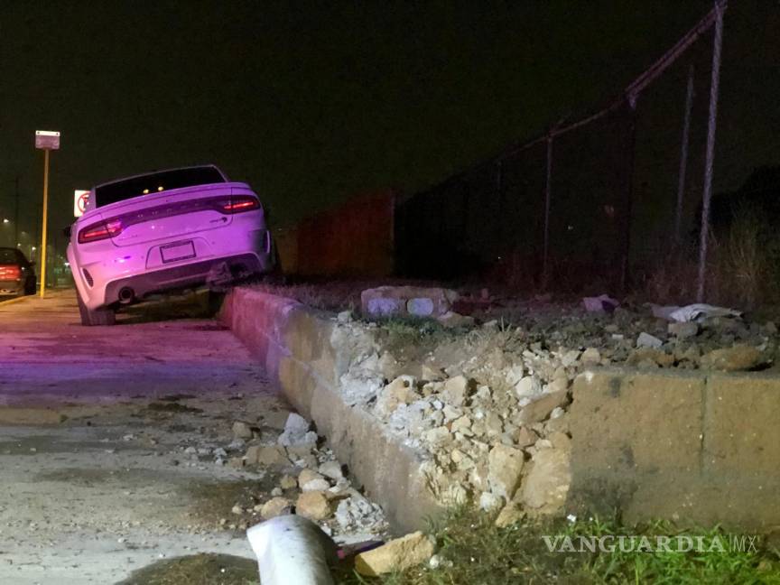 $!El auto terminó destrozando una pequeña barda.