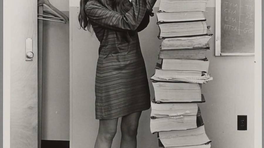 La directora de la División de Ingeniería de Software del Laboratorio de Instrumentación del MIT, Margaret Hamilton, junto a una pila de listados del software de vuelo del Apolo, desarrollado por ella y su equipo.