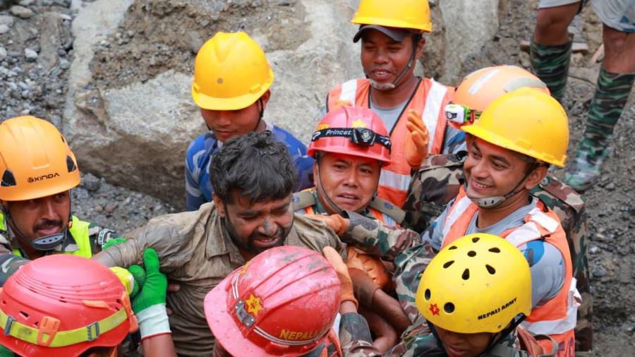 En esta imagen, distribuida por el ejército de Nepal, soldados rescatan con vida a un trabajador atrapado en un túnel durante una operación en el proyecto hidroeléctrico Trishuli-3A en el distrito de Rasuwa, en Nepal.