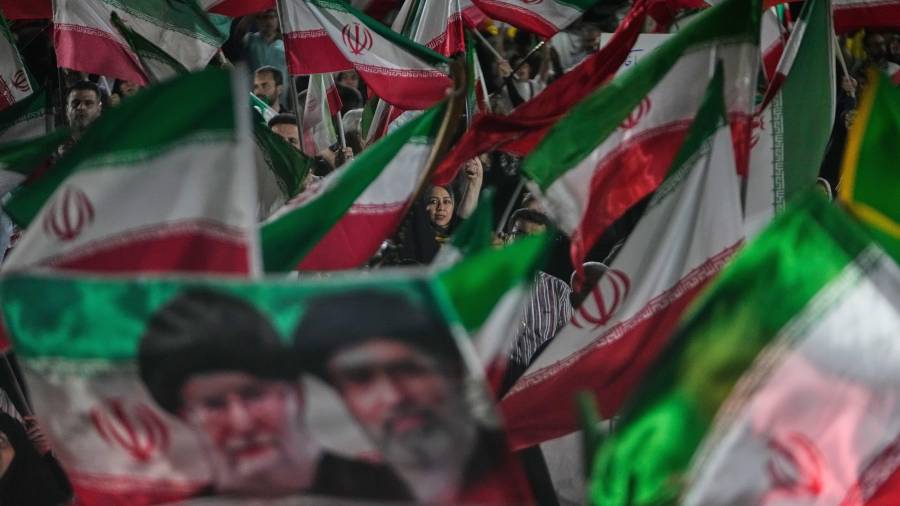 Manifestantes pro-gobierno con banderas iraníes y retratos del líder supremo ayatolá Mojtaba Jamenei (d) y su fallecido padre ayatolá Ali Jamenei, en Teherán, el 29 de mayo del 2026. (AP foto/Vahid Salemi)