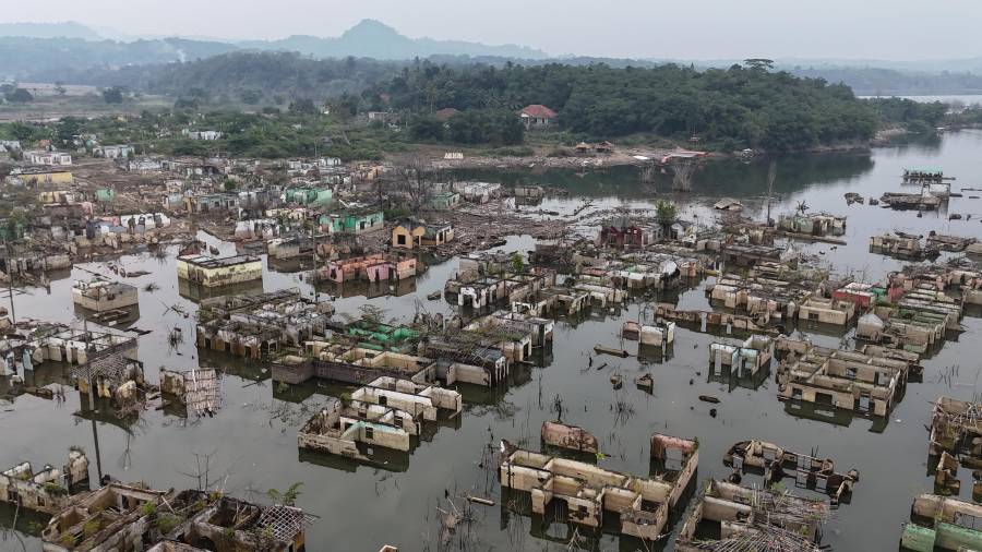 Casas que llevan mucho tiempo sumergidas se ven expuestas tras una sequía que bajó el nivel del agua de la presa Karian, en Lebak, en la provincia Banten, Indonesia.