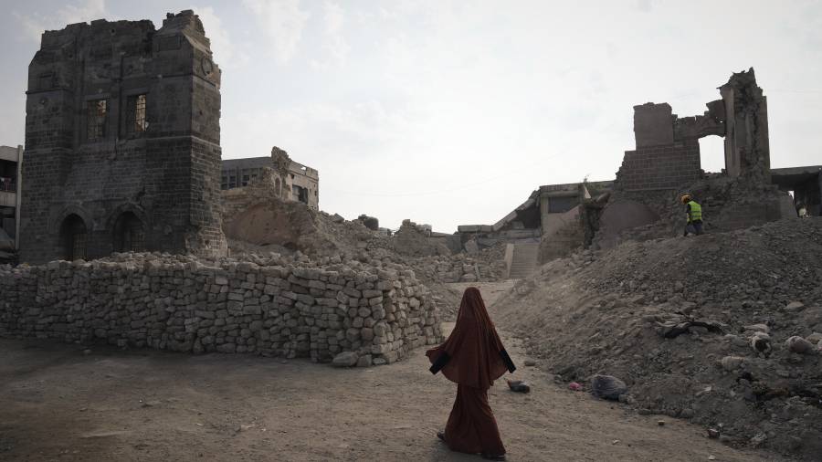 Una mujer palestina pasa por delante de las ruinas del histórico Palacio de Pachá en Ciudad de Gaza, destruido tras la campaña militar de Israel en Gaza, el jueves 13 de noviembre de 2025.