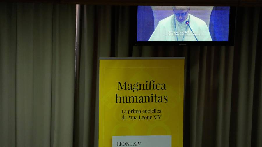 Pope Leo XIV, left, attends the presentation of his first encyclical, Magnifica humanitas: On Safeguarding the Human Person in the Time of Artificial Intelligence, at the Vatican, Monday, May 25, 2026. (AP Photo/Alessandra Tarantino)