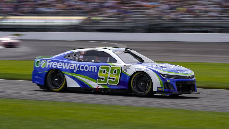 Daniel Suarez drives through a turn during a NASCAR Cup Series auto race at Indianapolis Motor Speedway in Indianapolis, Sunday, Aug. 13, 2023. (AP Photo/Michael Conroy)