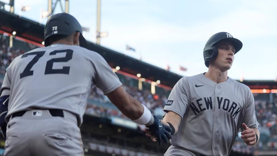 New York Yankees' Ben Rice, right, is congratulated by José Caballero (72) after scoring against the San Francisco Giants during the fifth inning of a baseball game in San Francisco, Wednesday, March 25, 2026. (AP Photo/Jeff Chiu)