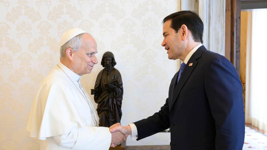 In this handout photo provided by Vatican Media Pope Leo XIV greets U.S. Secretary of State Marco Rubio, right, upon his arrival for talks in the pope's private library at the Vatican, Thursday, May 7, 2026. (Vatican Media via AP)