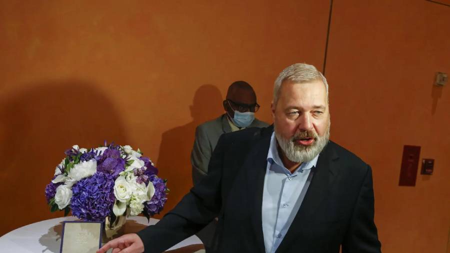 El Premio Nobel de la Paz Dmitry Muratov, editor del diario ruso Novaya Gazeta, posa junto a su medalla de 23 quilates antes de que sea subastada en Times Center el lunes 20 de junio de 2022 en Nueva York.
