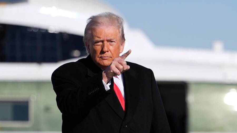 President Donald Trump points as he boards Air Force One for a trip to Detroit, Tuesday, Jan. 13, 2026, in Joint Base Andrews, Md. (AP Photo/Evan Vucci)