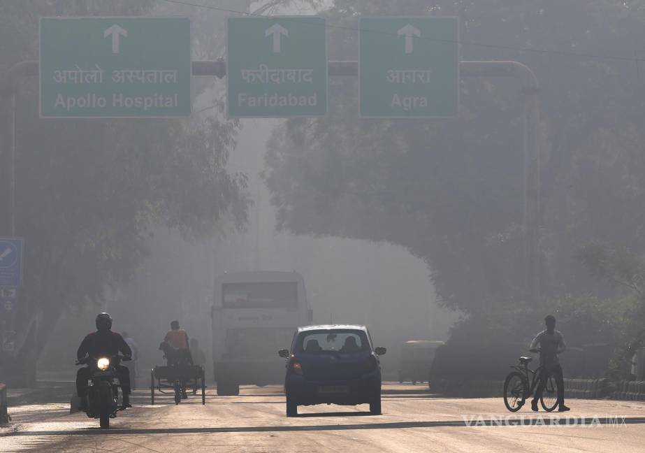 $!A motorcyclist drives on the wrong side of the road amidst morning haze and toxic smog in New Delhi, India. AP/Manish Swarup