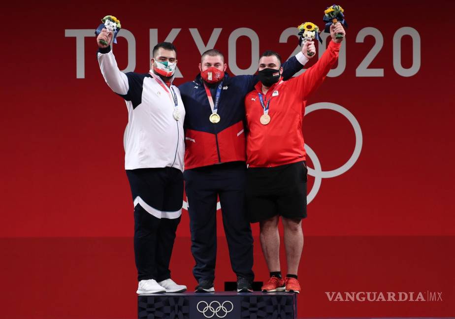 $!El medallista de plata Ali Davoudi (i) de Irán, el medallista de oro Lasha Talakhadze (c) de Georgia y el medallista de bronce Man Asaad (d) de pose siria en la ceremonia de premiación enTokio 2020. EFE