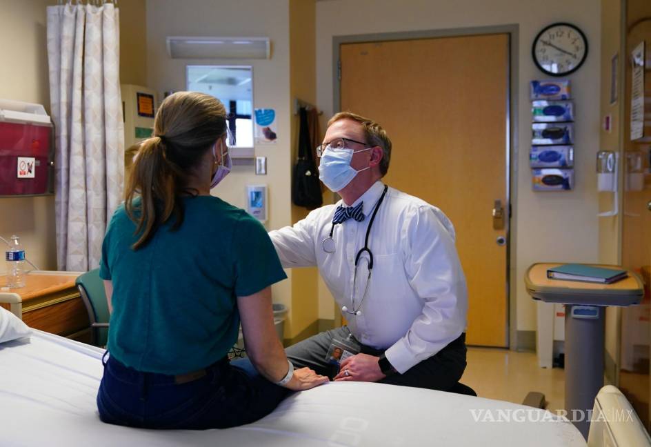 $!Kathleen Jade es examinada por el Dr. Will Gwin antes de recibir su tercera dosis de una vacuna experimental contra el cáncer de mama.