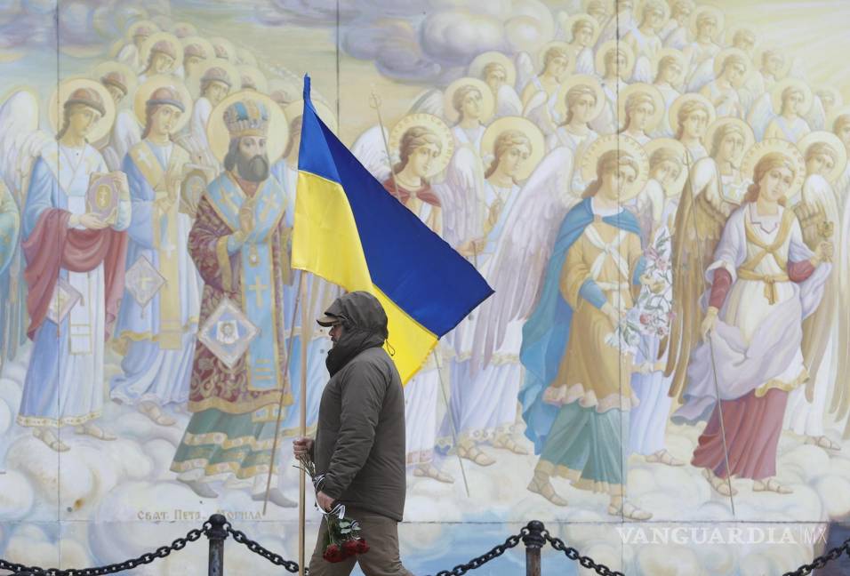 $!Un hombre con una bandera ucraniana en el funeral en la Catedral de San Mykhailivsky en Kiev de la difunta médica de combate Maria-Khrystyna Dvoinik.