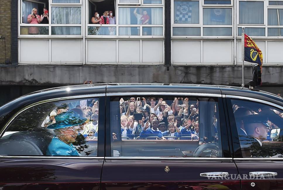 $!Imagen del 16 de julio de 2015. Los residentes de Dagenham y Barking mirando a la reina Isabel II de Gran Bretaña en un automóvil.