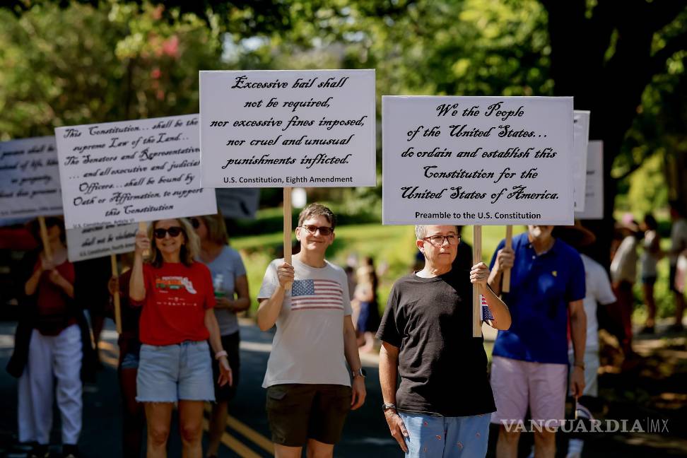 $!Personas muestran secciones de la Constitución estadounidense en protesta en el desfile del 4 de julio en Georgia.