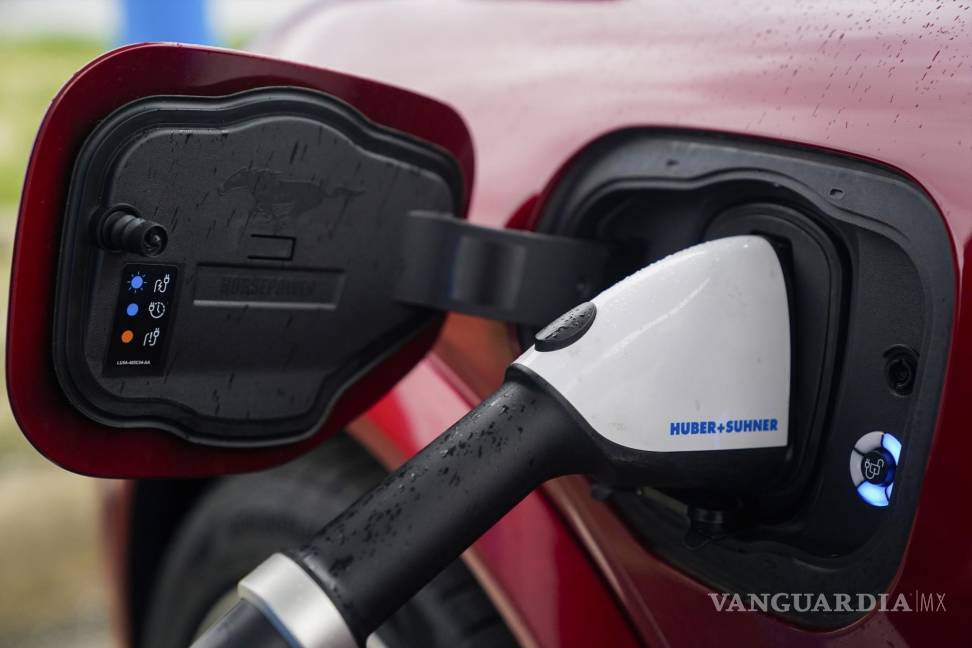 $!FILE - A 2023 Ford Mustang Mach-E charges, March 8, 2024, at an electric vehicle charging station in London, Ohio. (AP Photo/Joshua A. Bickel, File)