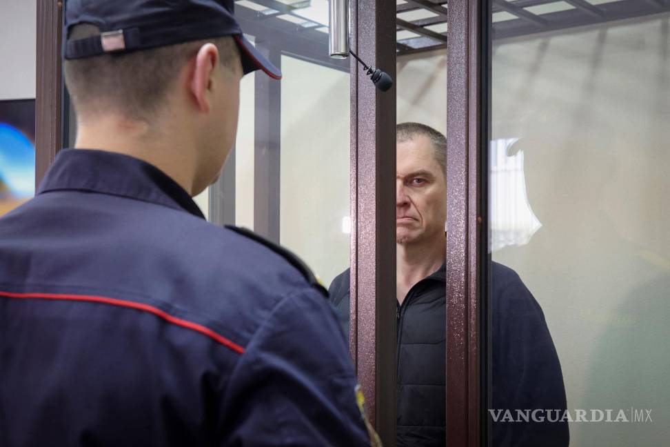 $!FILE -Journalist Andrzej Poczobut stands in a defendants' cage during a court session in Grodno, Belarus, Jan. 16, 2023. (Leonid Shcheglov/Pool via AP, File)