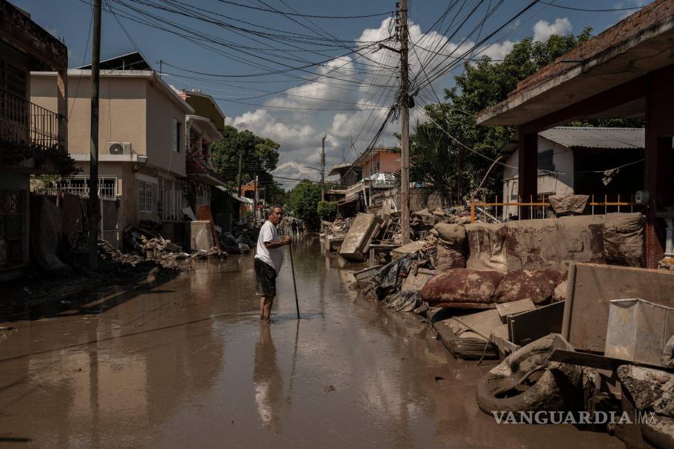 $!Una calle inundada en Poza Rica, México. Al menos 70 personas murieron a causa de las fuertes lluvias que azotaron el país la semana pasada.