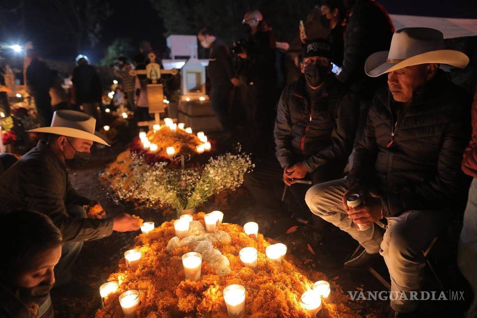 $!Familiares de fallecidos acuden a poner flores y velas en el panteón municipal de Tzurumutaro, en el estado de Michoacán, México. EFE/Iván Villanueva