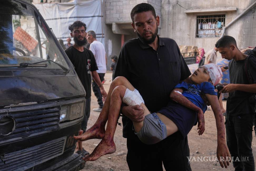 $!Un hombre lleva el cuerpo de Abdul Rahman, de 12 años, un niño palestino que murió en un ataque militar israelí en la Franja de Gaza.