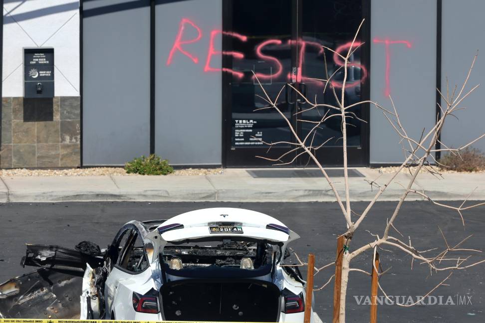 $!Un vehículo tesla quemado se ve en un centro de colisión de Tesla en Las Vegas. El graffiti dice resistan.