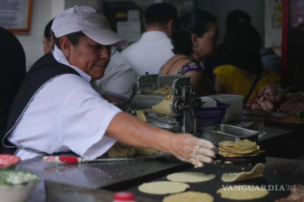 $!Una empleada lanza una tortilla a la plancha en la taquería Tacos El Califa de León en Ciudad de México.