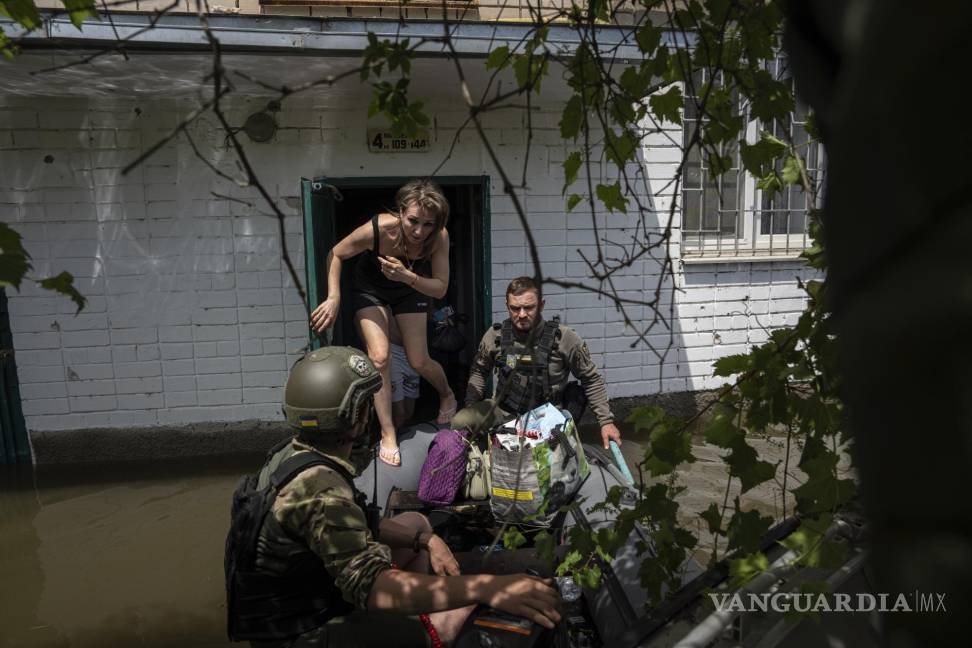 $!Muchas embarcaciones pequeñas, con rescatistas y soldados a bordo, cruzan desde zonas controladas por Ucrania en la orilla oeste para rescatar a civiles desesperados varados en tejados, áticos y otras zonas altas.