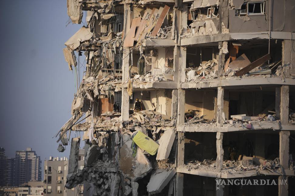 $!Fuerzas de seguridad israelíes inspeccionan un edificio destruido por un misil lanzado desde Irán, cerca de Tel Aviv, Israel.