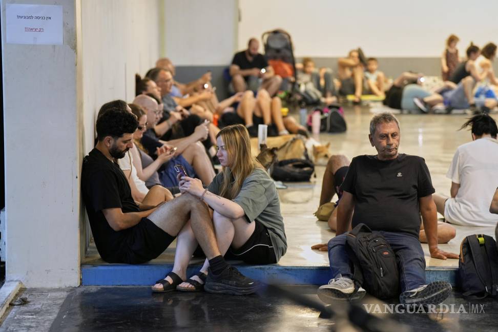 $!Israelíes se sientan en un refugio mientras las sirenas advierten de fuego inminente en Tel Aviv.