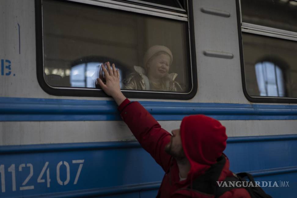 $!Los ucranianos desplazados en un tren con destino a Polonia se despiden en Lviv, en el oeste de Ucrania.