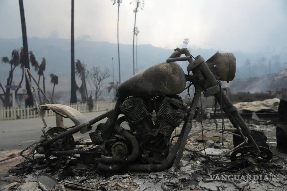 $!Un vehículo y otras estructuras se queman mientras el incendio de Palisades arrasa un vecindario en el barrio de Pacific Palisades de Los Ángeles.