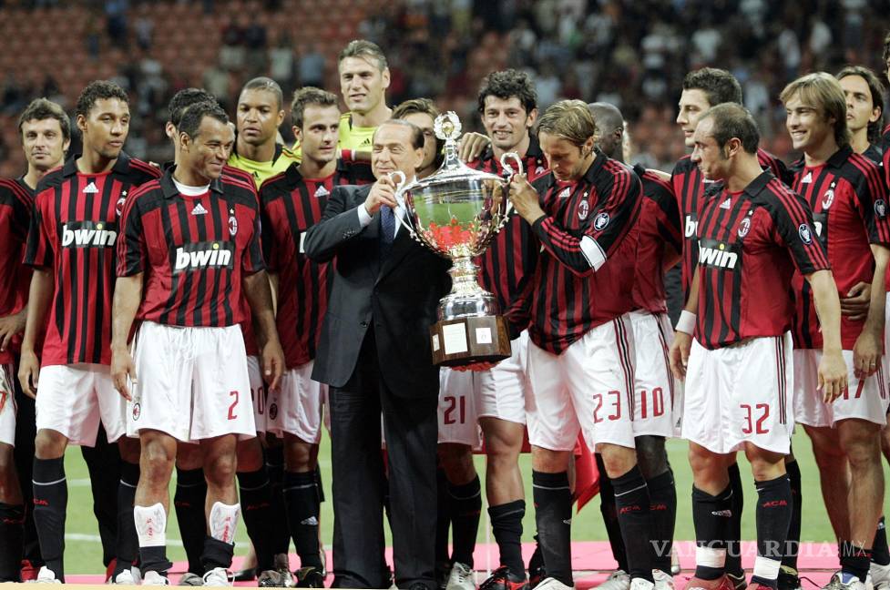 $!FILE - AC Milan president Silvio Berlusconi, center in dark suit, celebrates with the team after defeating Juventus to win the Luigi Berlusconi Trophy exhibition soccer match at the San Siro stadium in Milan, Italy, on Aug. 17, 2007. Berlusconi, the boastful billionaire media mogul who was Italy's longest-serving premier despite scandals over his sex-fueled parties and allegations of corruption, died, according to Italian media. He was 86. (AP Photo/Alberto Pellaschiar, File)