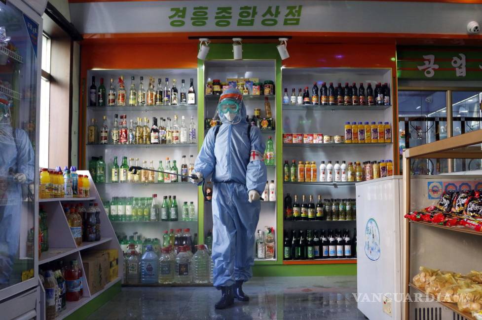 $!Un empleado de Kyonghung Foodstuff General Store desinfecta la sala de exposición en Pyongyang, Corea del Norte.