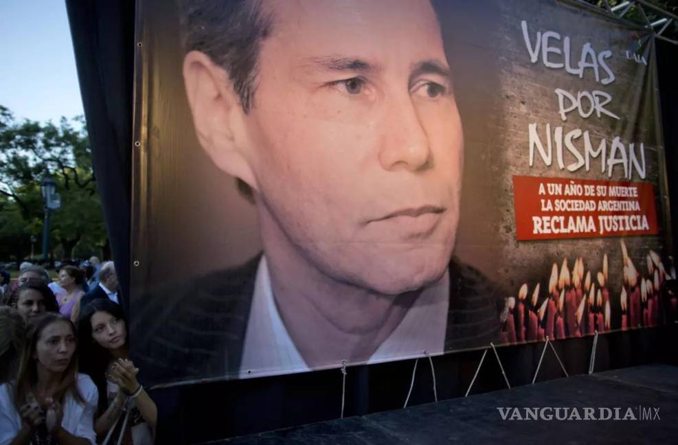 $!Fotografía del 18 de enero de 2016, mujeres se paran junto a una foto del difunto fiscal Alberto Nisman en el primer aniversario de su muerte en Buenos Aires.